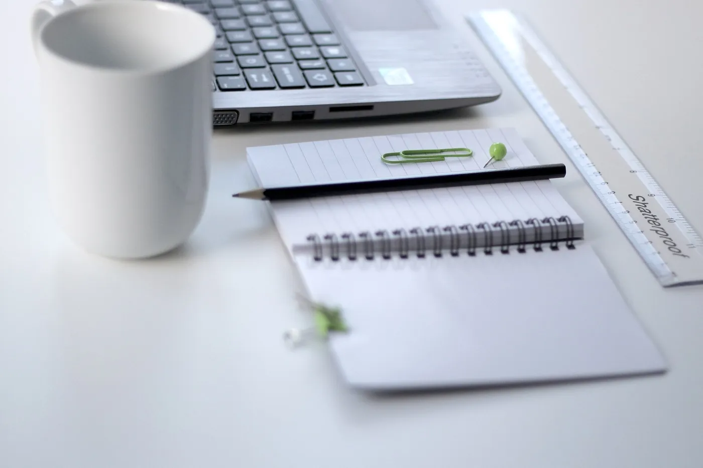 A laptop and notebook set out for project planning